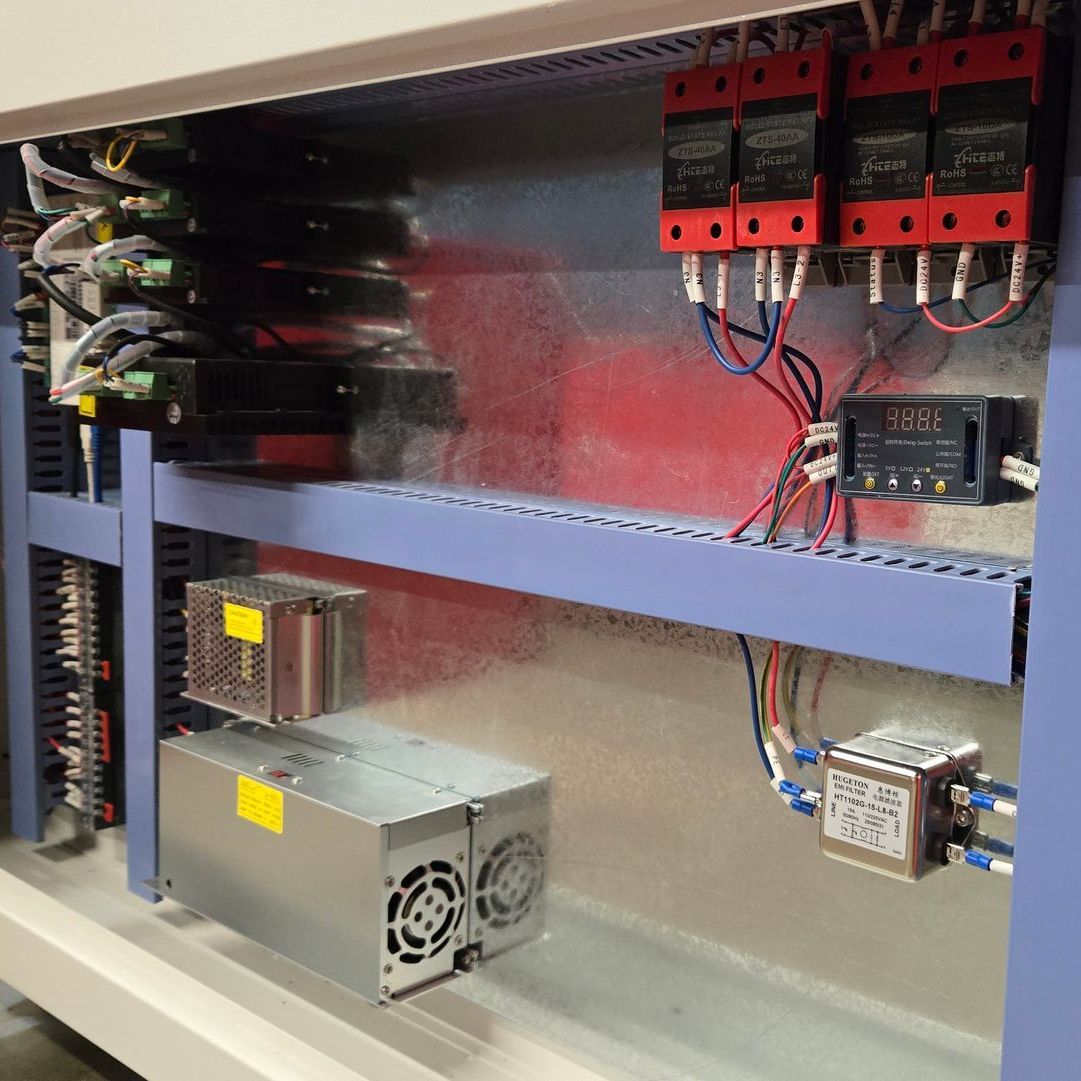 inside door panel of a rabbit laser cutter showing power supplies and wires