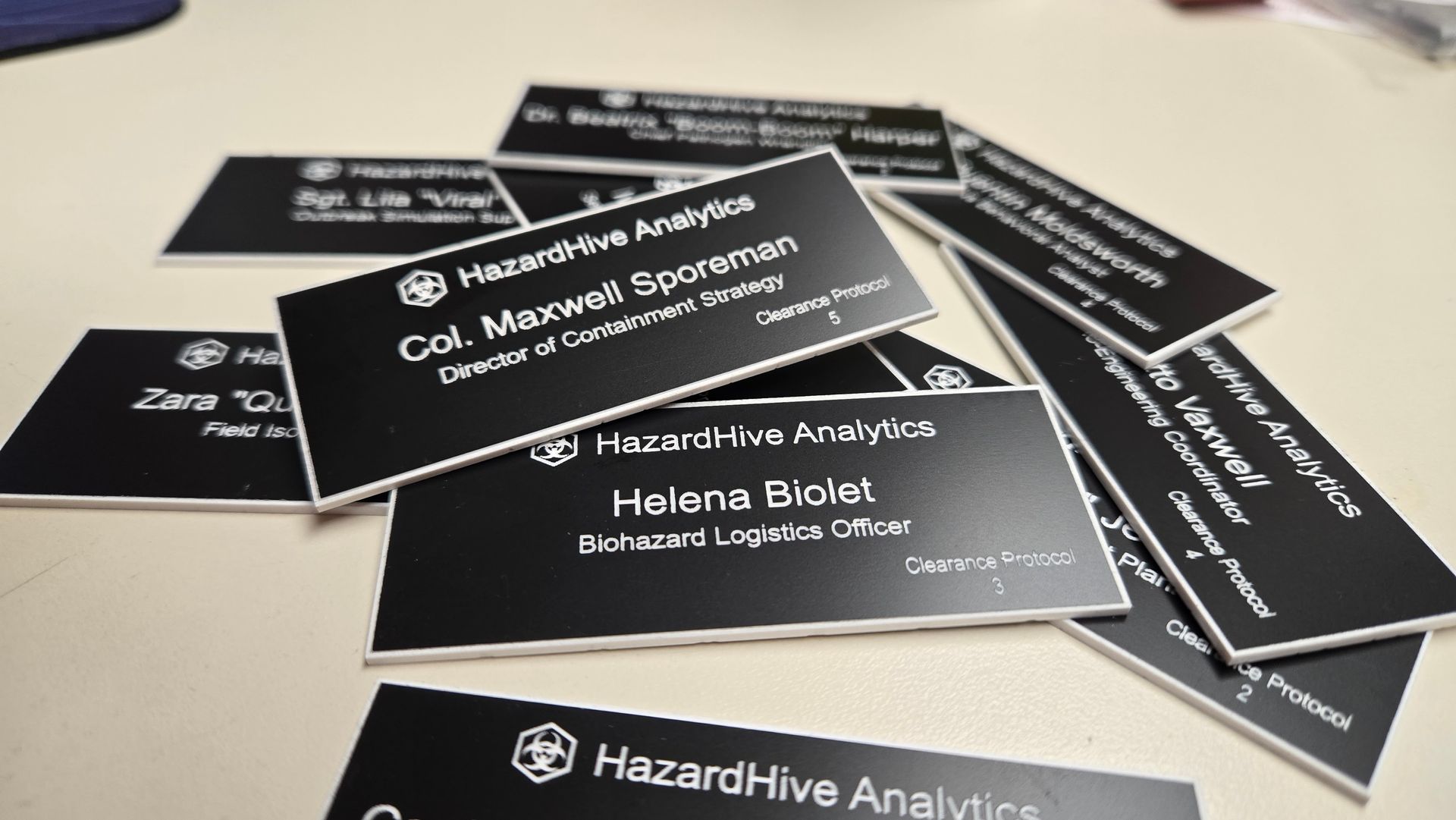 A pile of completed nametags created with LightBurn and Rabbit Laser CO2 laser engraving