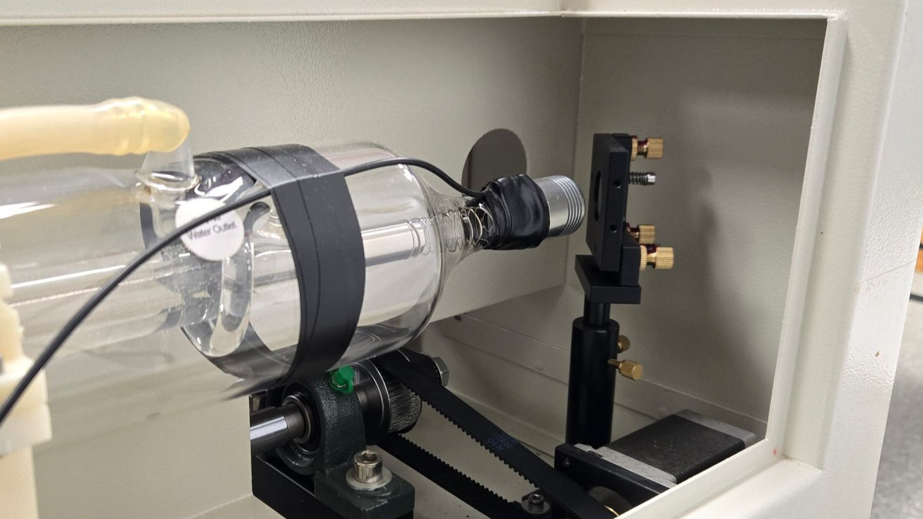 Laser tube aimed at mirror 1 inside flying optics laser machine during beam alignment setup