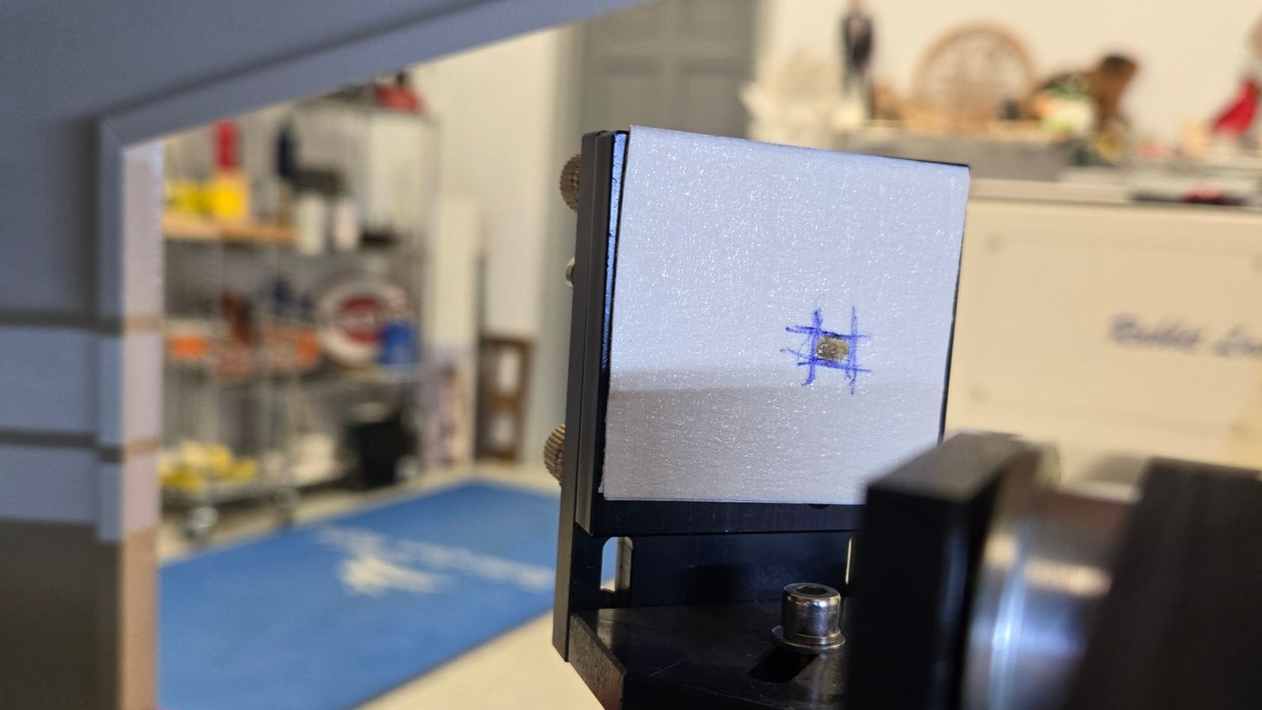 Laser beam test burn mark on masking tape target during flying optics alignment procedure