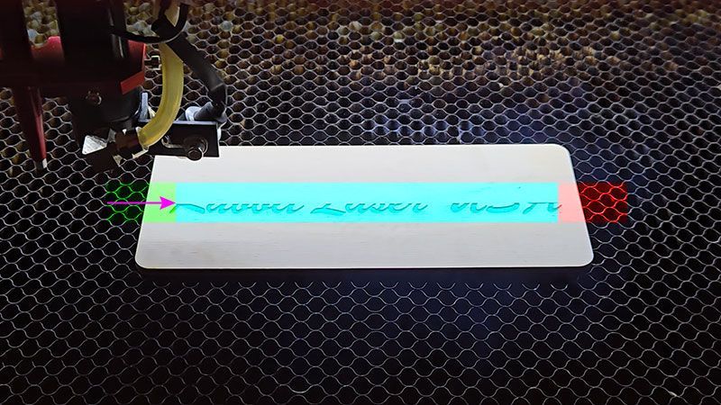 Laser engraving head approaching the start of artwork showing overscan acceleration area before engraving begins.
