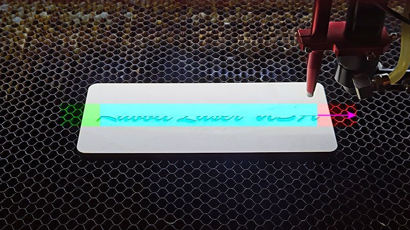 Laser engraving head exiting artwork showing overscan deceleration area after the engraving pass.
