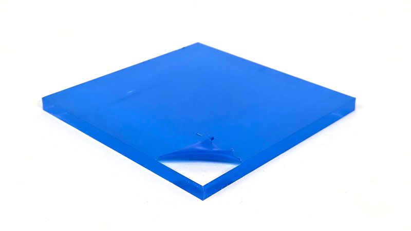 Blue extruded acrylic sheet with protective plastic film lifted at the corner, revealing smooth glossy surface.