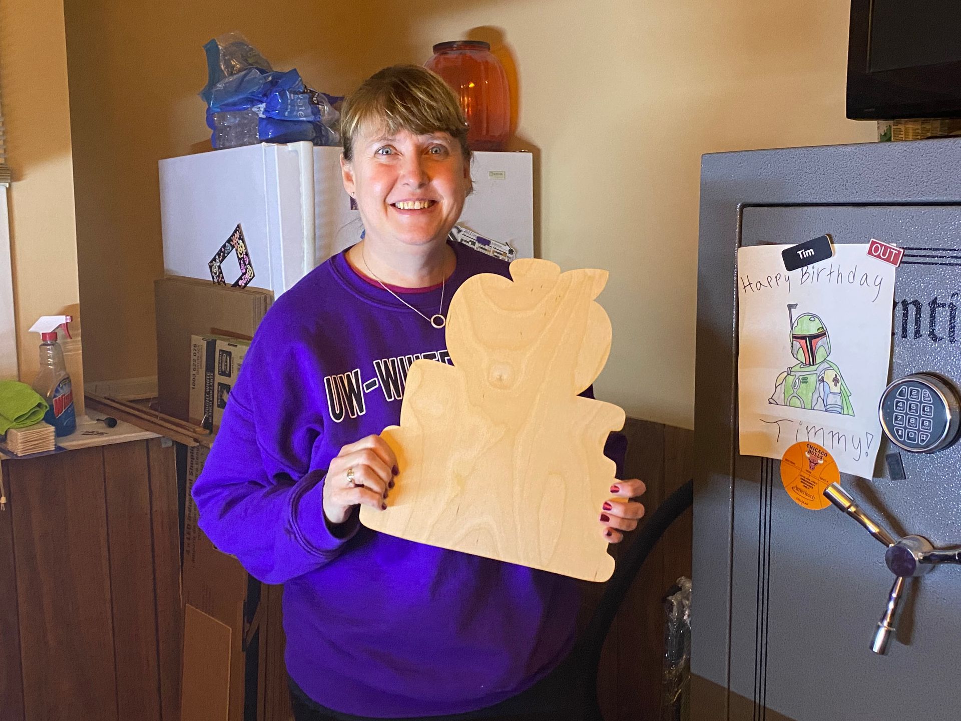 Happy customer posing with their laser cut project from a Rabbit Laser