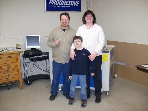 family posing next to their rabbit laser usa machine 