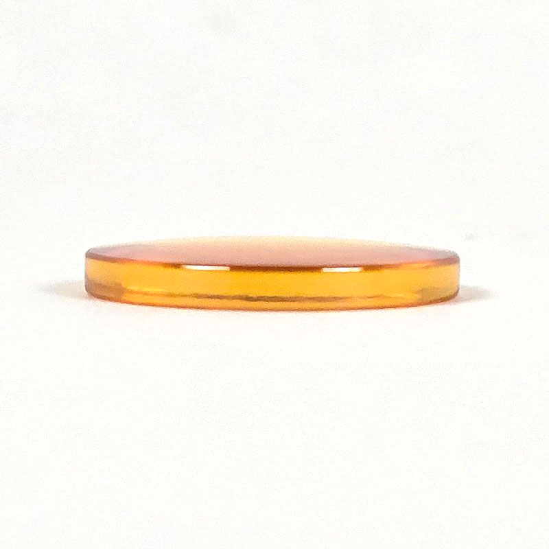CO2 laser lens resting flat showing curved and flat sides for proper orientation
