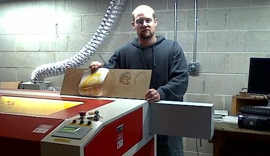 man posing with a finished laser engraving by their Rabbit laser usa machine