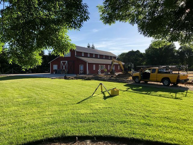 Yellow Truck is Parked in Front of a Red Barn – Elk Grove, CA – AVM Concrete