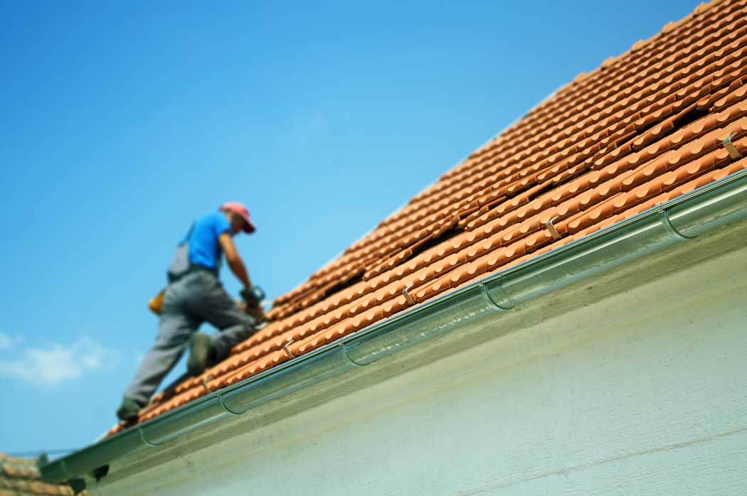 Worker on Roof for Maintenance