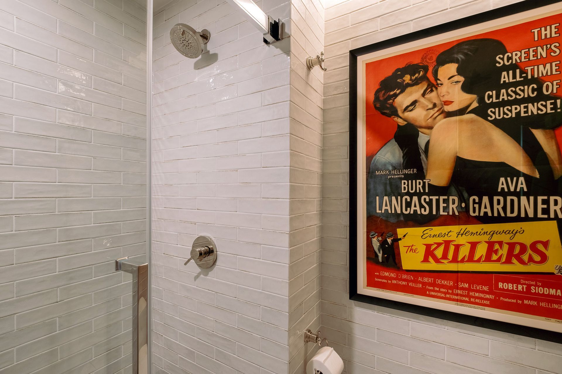 A bathroom with a shower with white tiles.