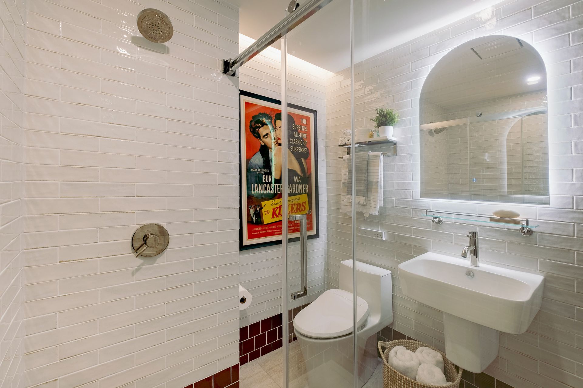 A bathroom with a toilet, sink, and shower.