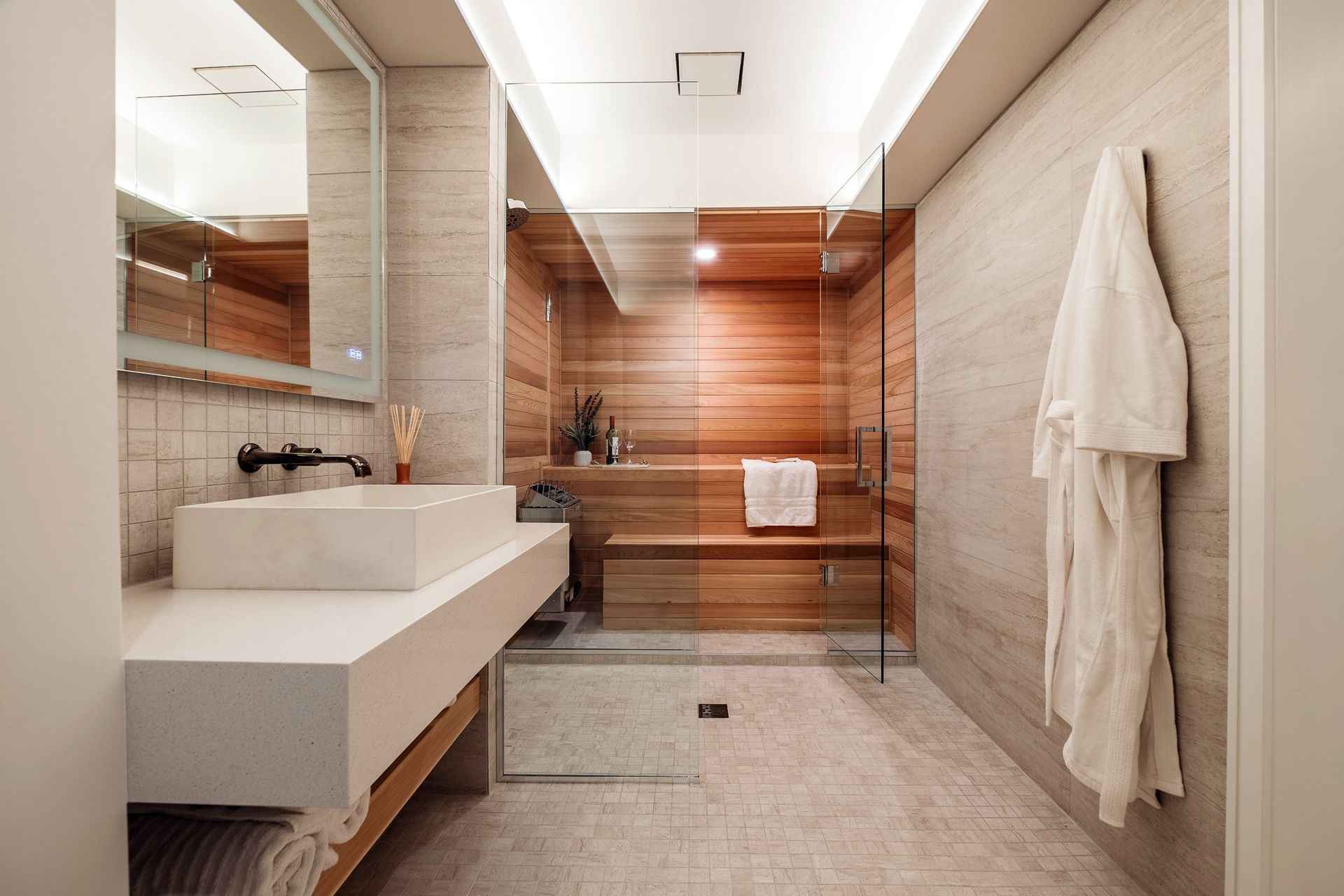 A bathroom with a sink and a walk in shower.