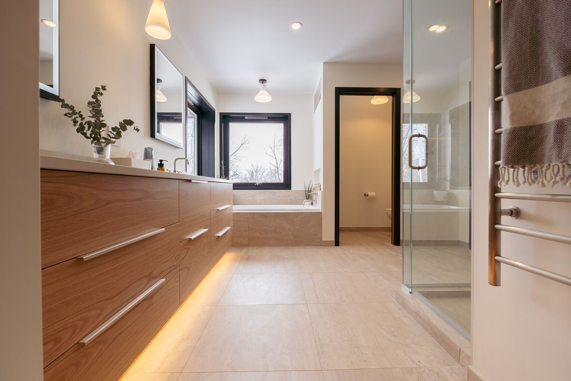 A bathroom with two sinks, a tub, and a walk in shower.