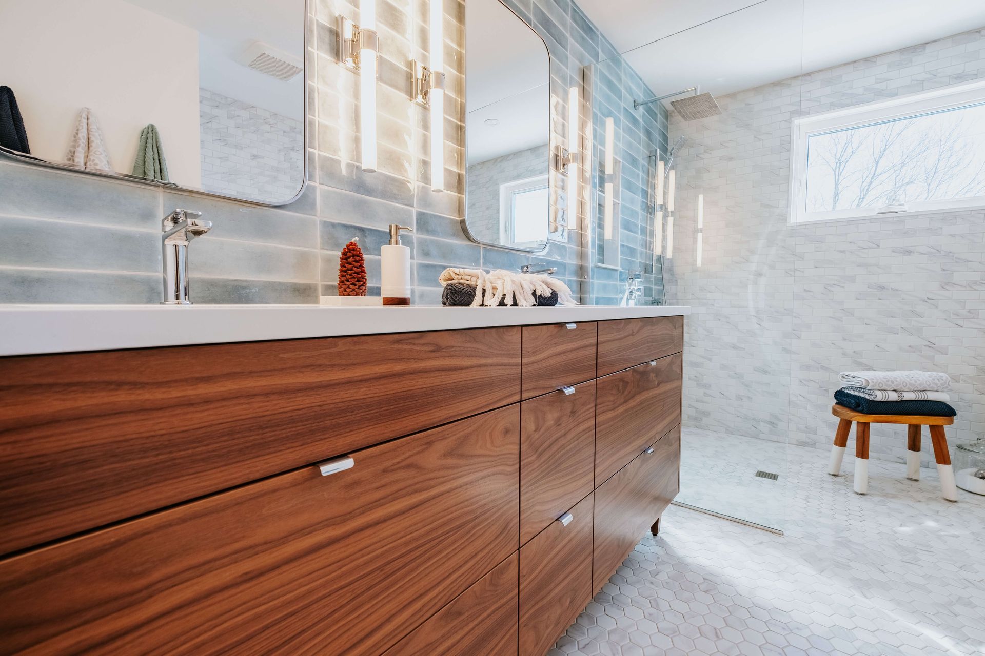 A bathroom with two sinks and a mirror.