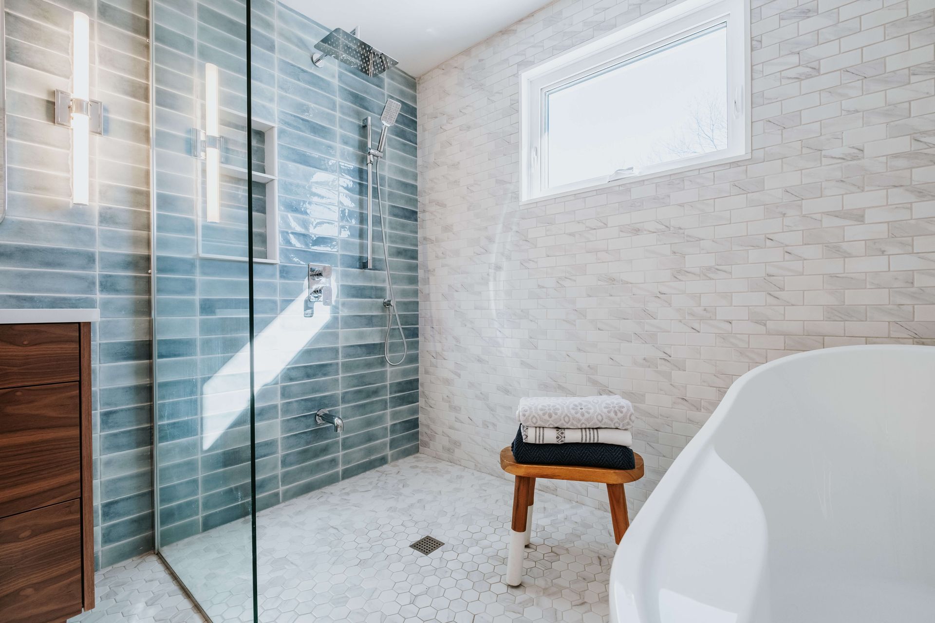 A bathroom with a walk in shower and a bathtub.