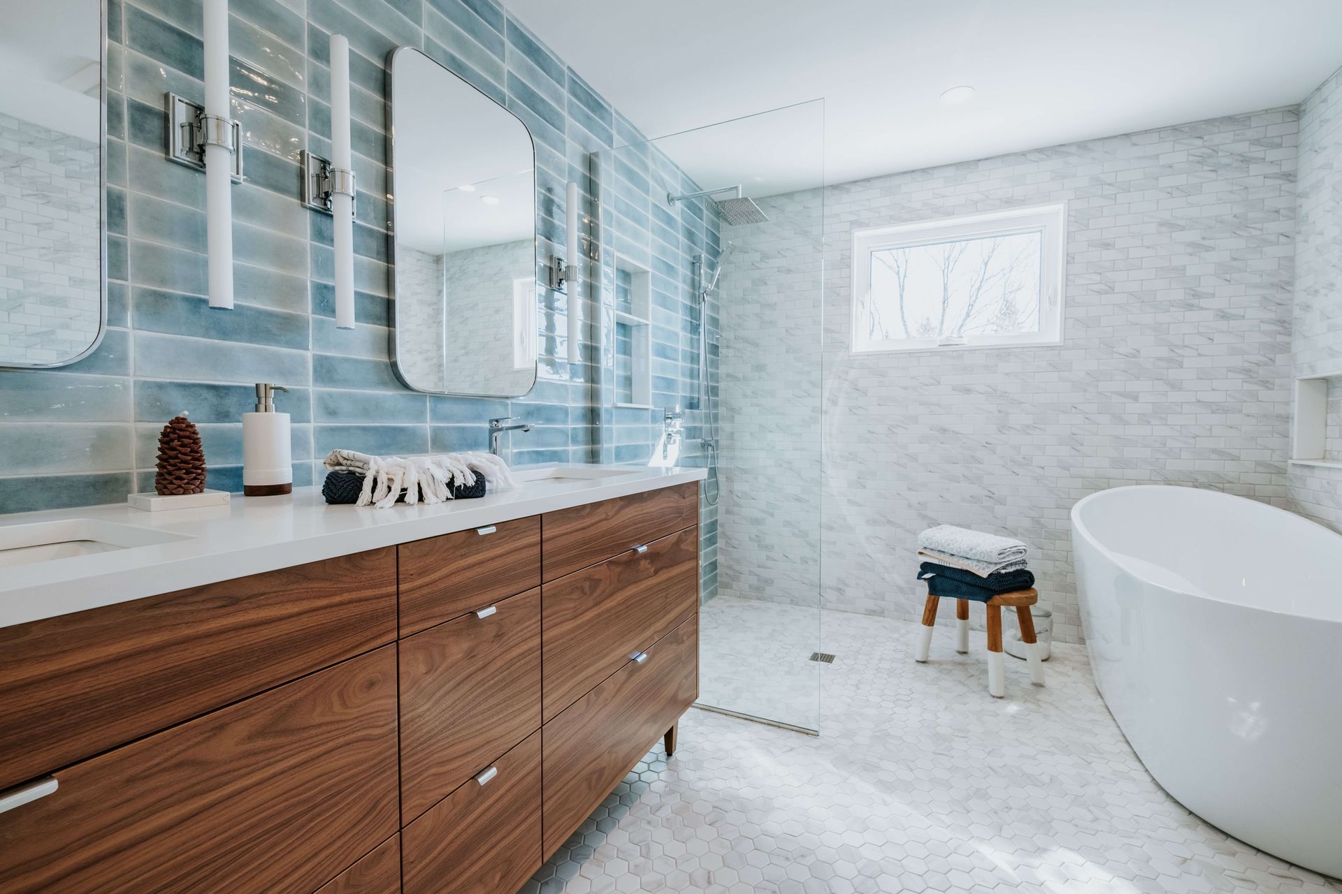 A bathroom with a bathtub, sink and mirror.
