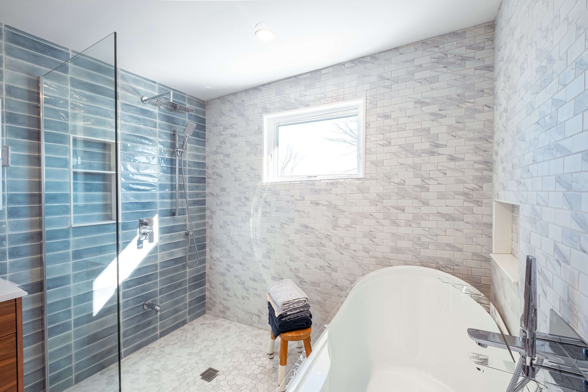 A bathroom with a bathtub and a walk in shower.