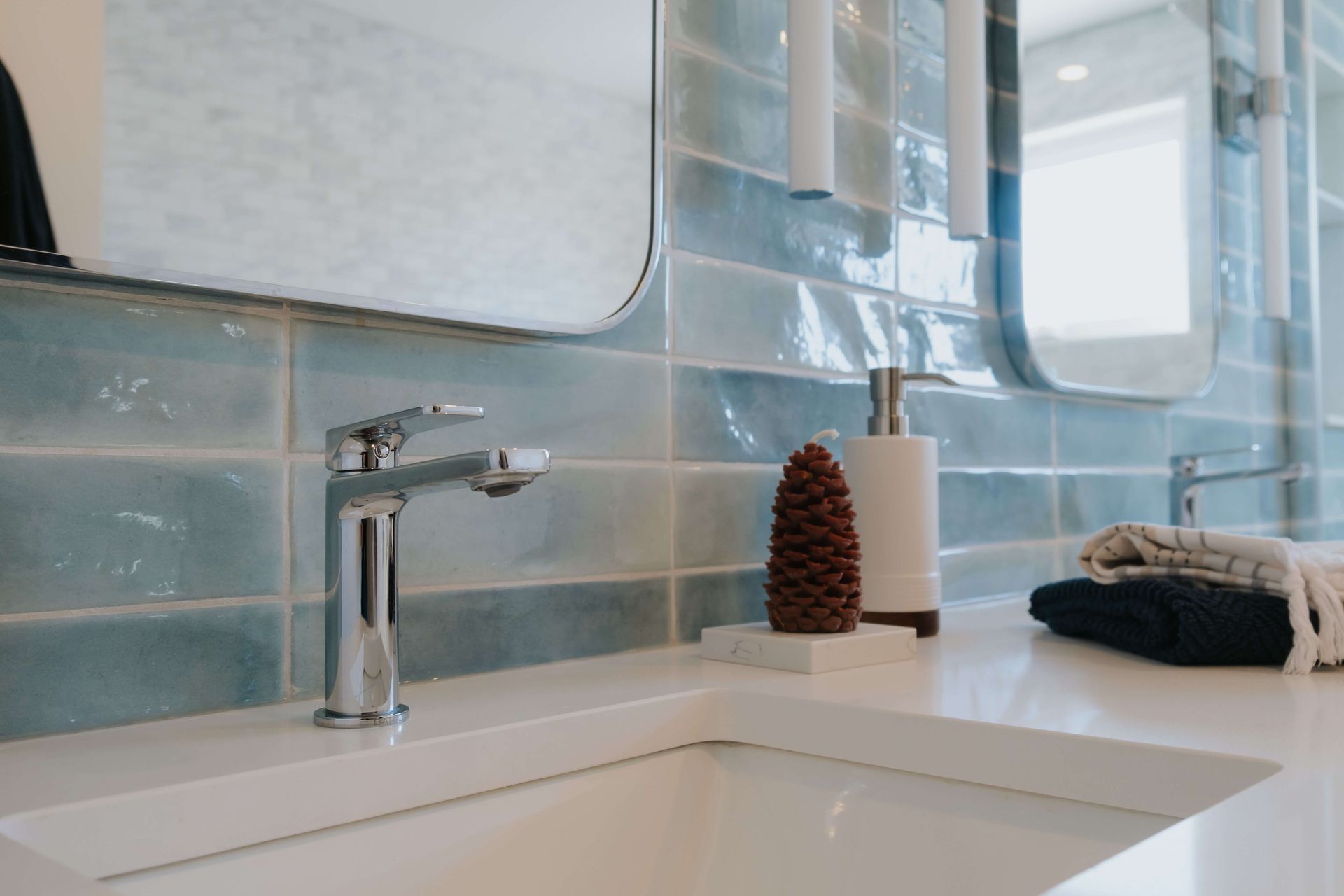 A bathroom sink with a faucet and a mirror.