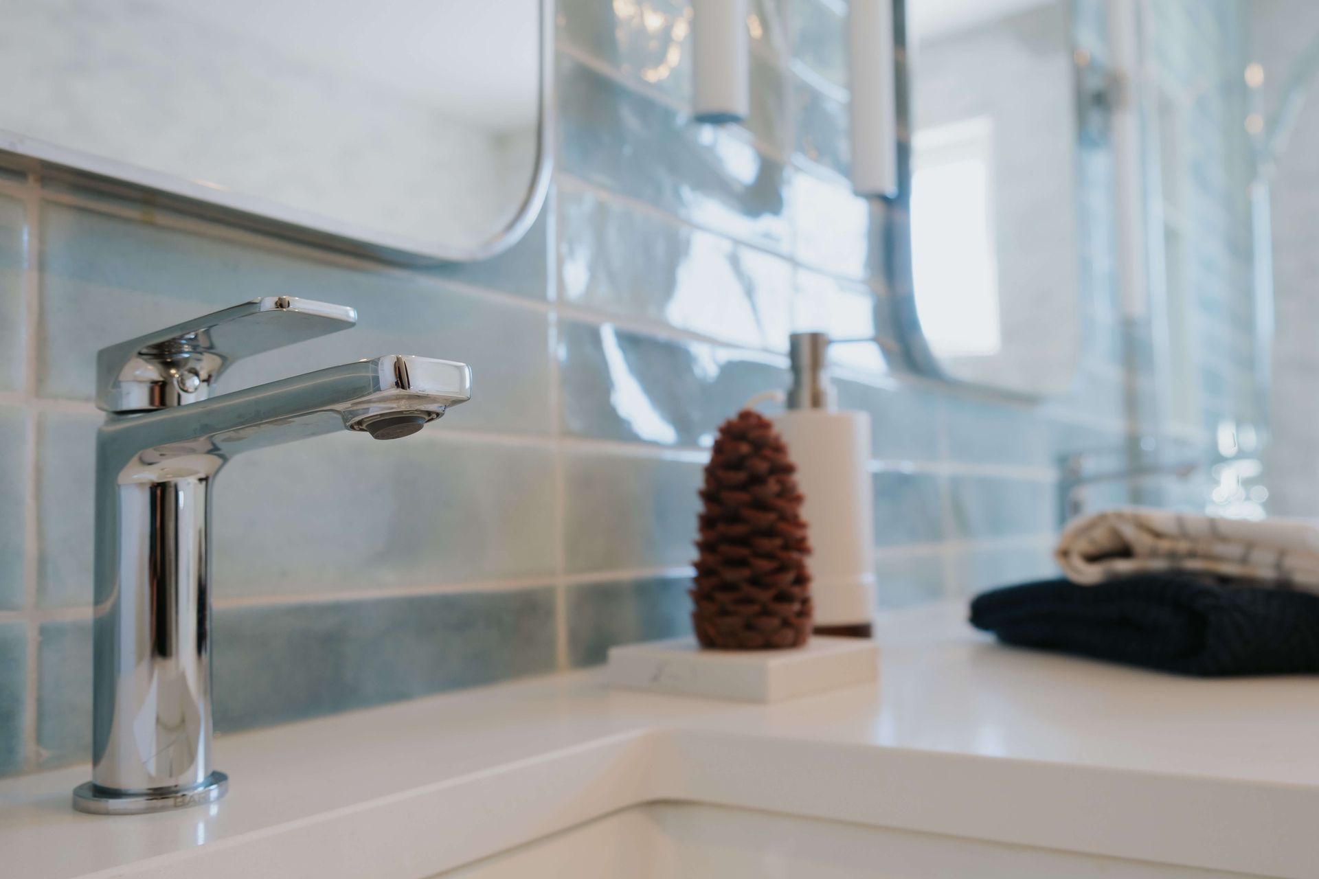 A bathroom sink with a faucet and a mirror.