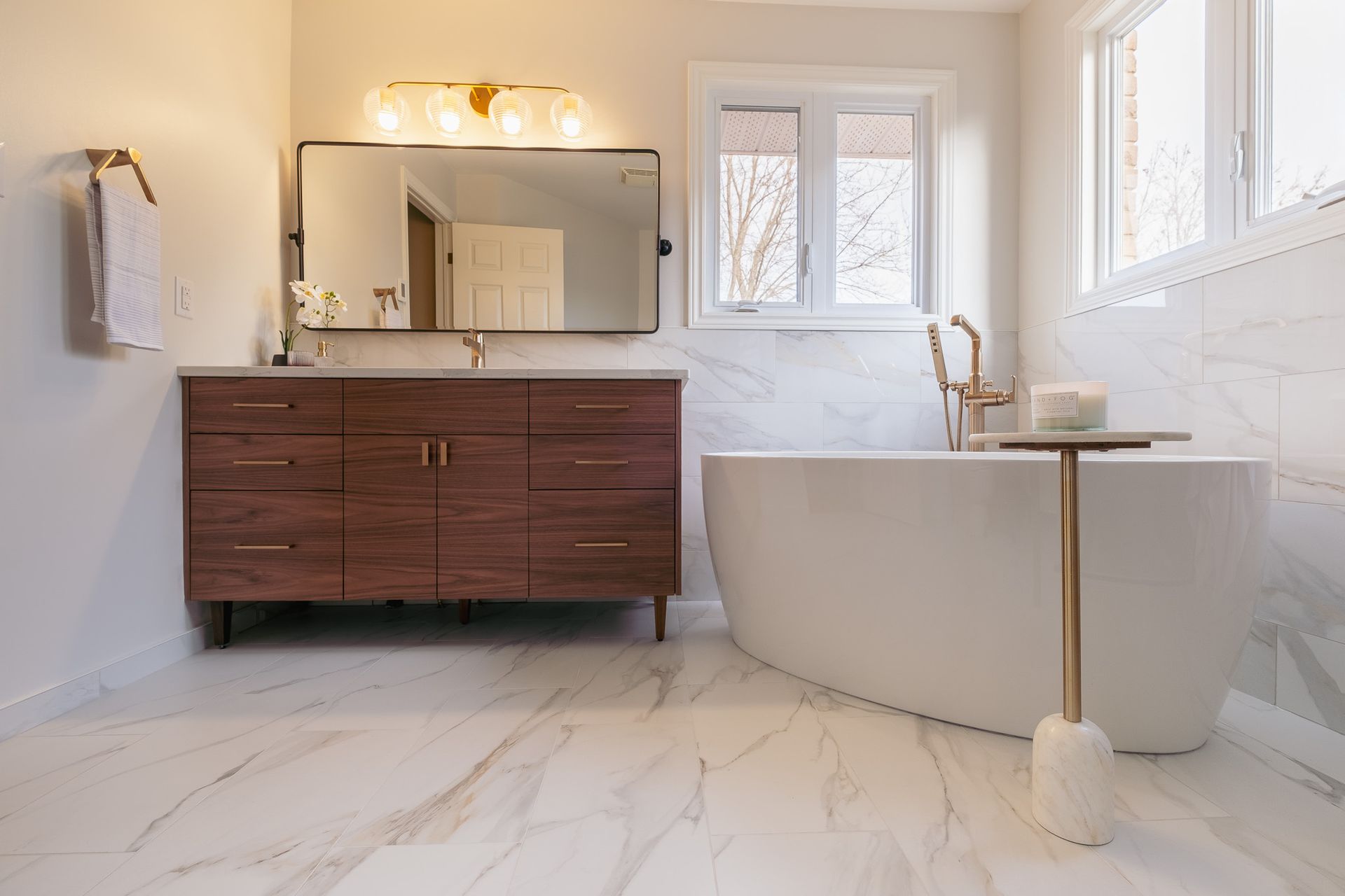 A bathroom with a bathtub, and sink.
