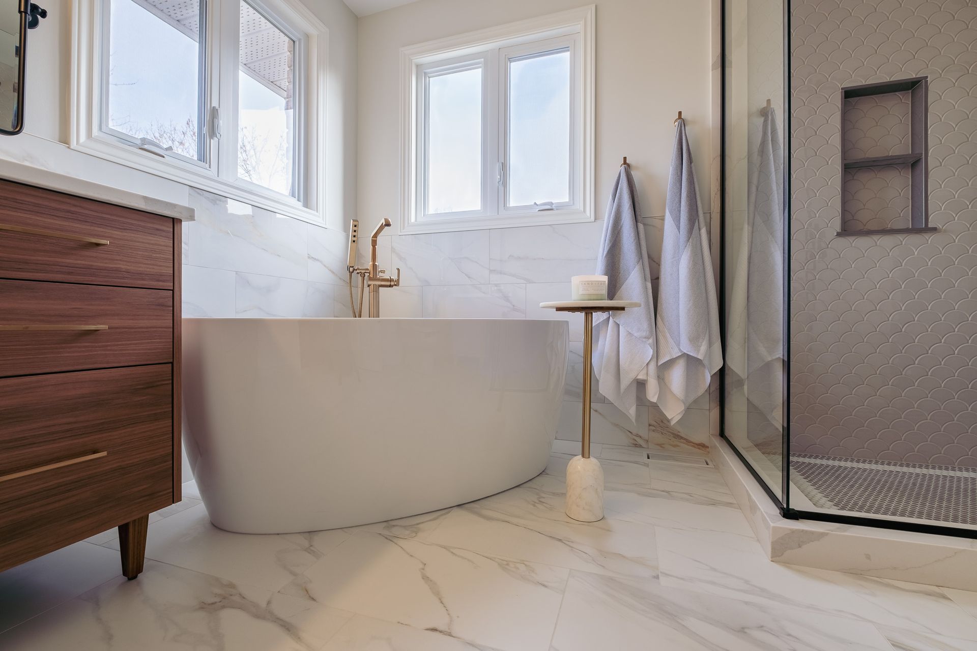 A bathroom with a bathtub and a walk in shower.