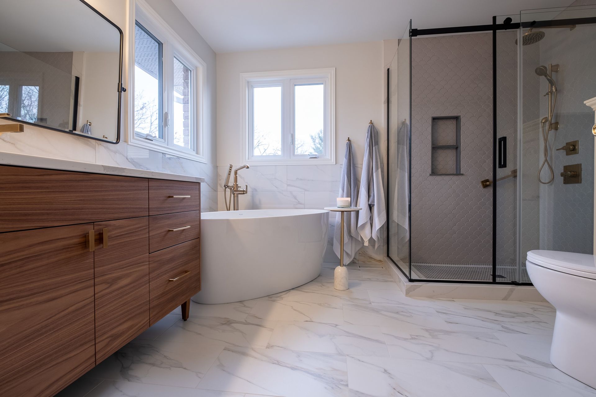 A bathroom with a bathtub, toilet, sink and shower.