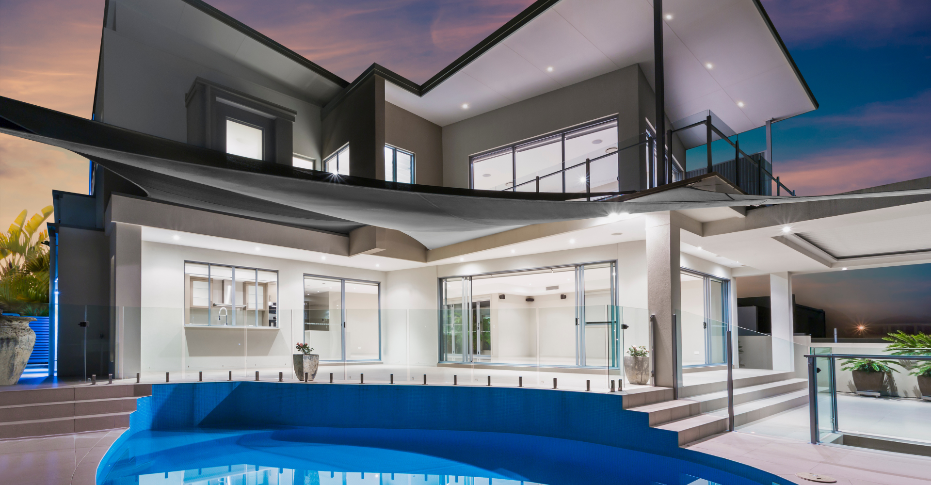 A large house with a swimming pool in front of it.