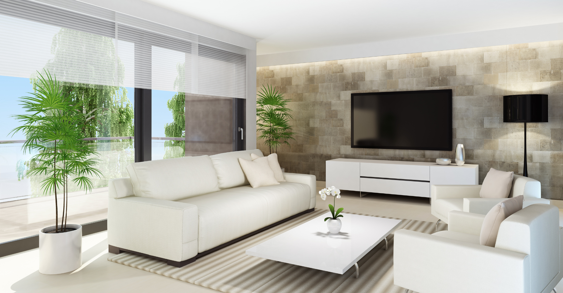 A living room with white furniture and a flat screen tv