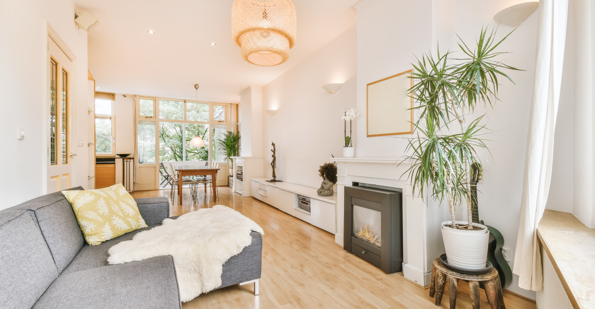 A living room with a couch , fireplace , and plant.