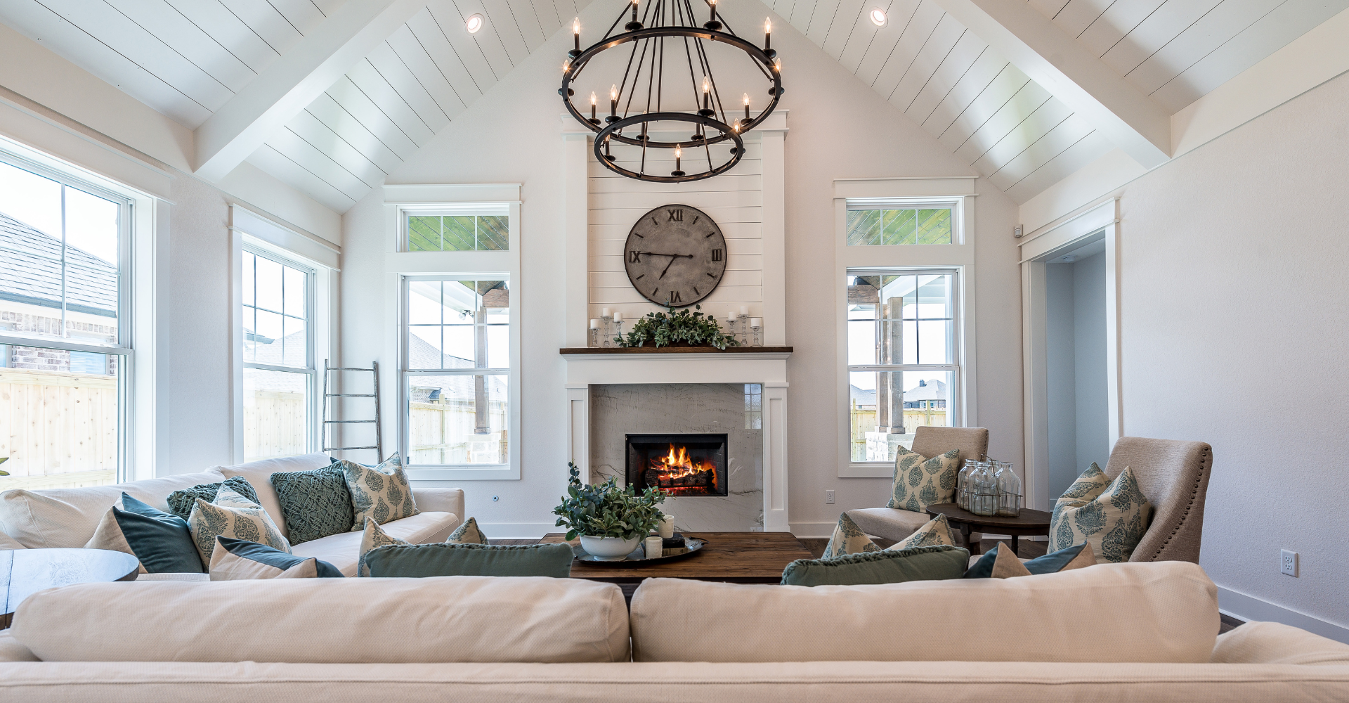 A living room with a fireplace and a clock on the wall