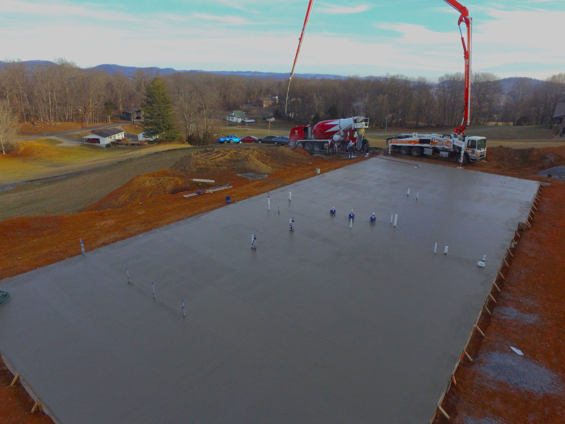 Compass Construction laying a large concrete foundation for a large barndominium 
