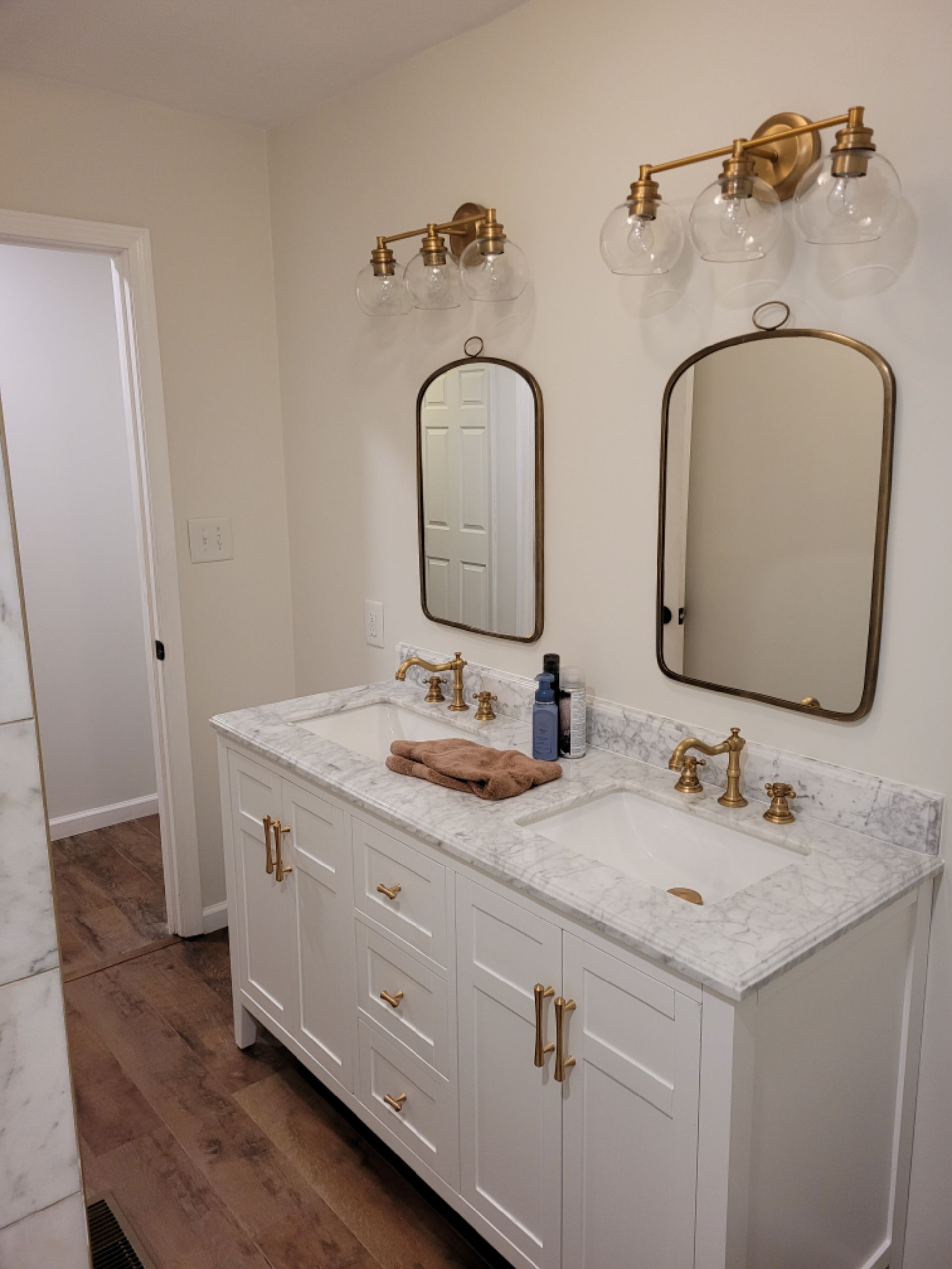 A bathroom with two sinks and two mirrors.