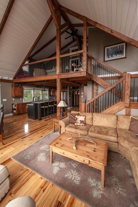 Gorgeous staircase leading to ktichen and living area inside a luxury barndominium.