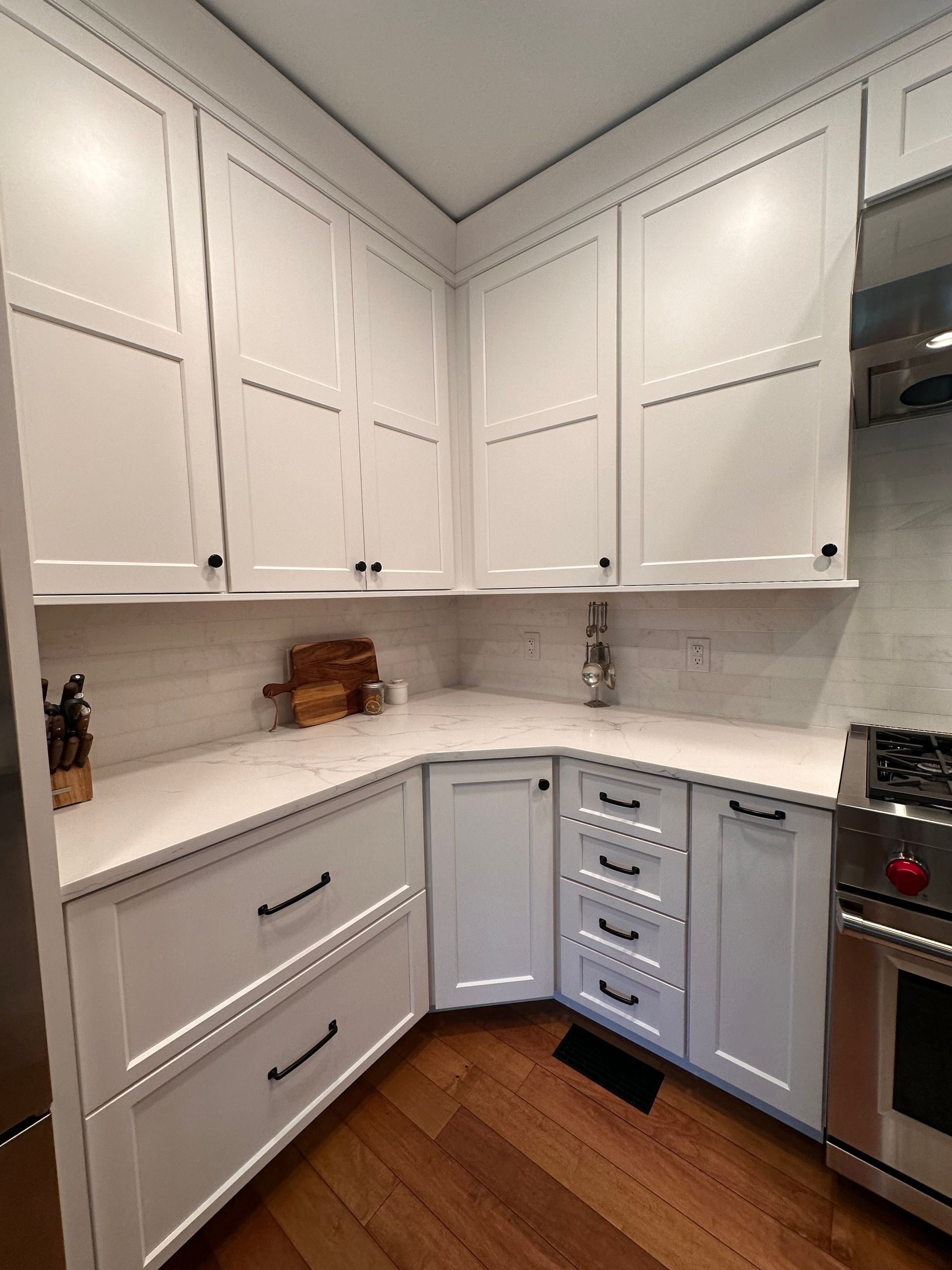 A kitchen with white cabinets and stainless steel appliances.