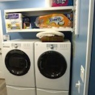 A washer and dryer are sitting next to each other in a laundry room.