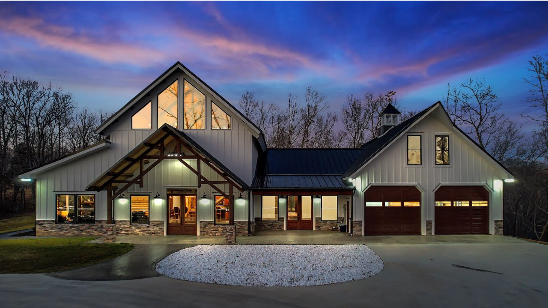 A large house with a lot of windows is lit up at night