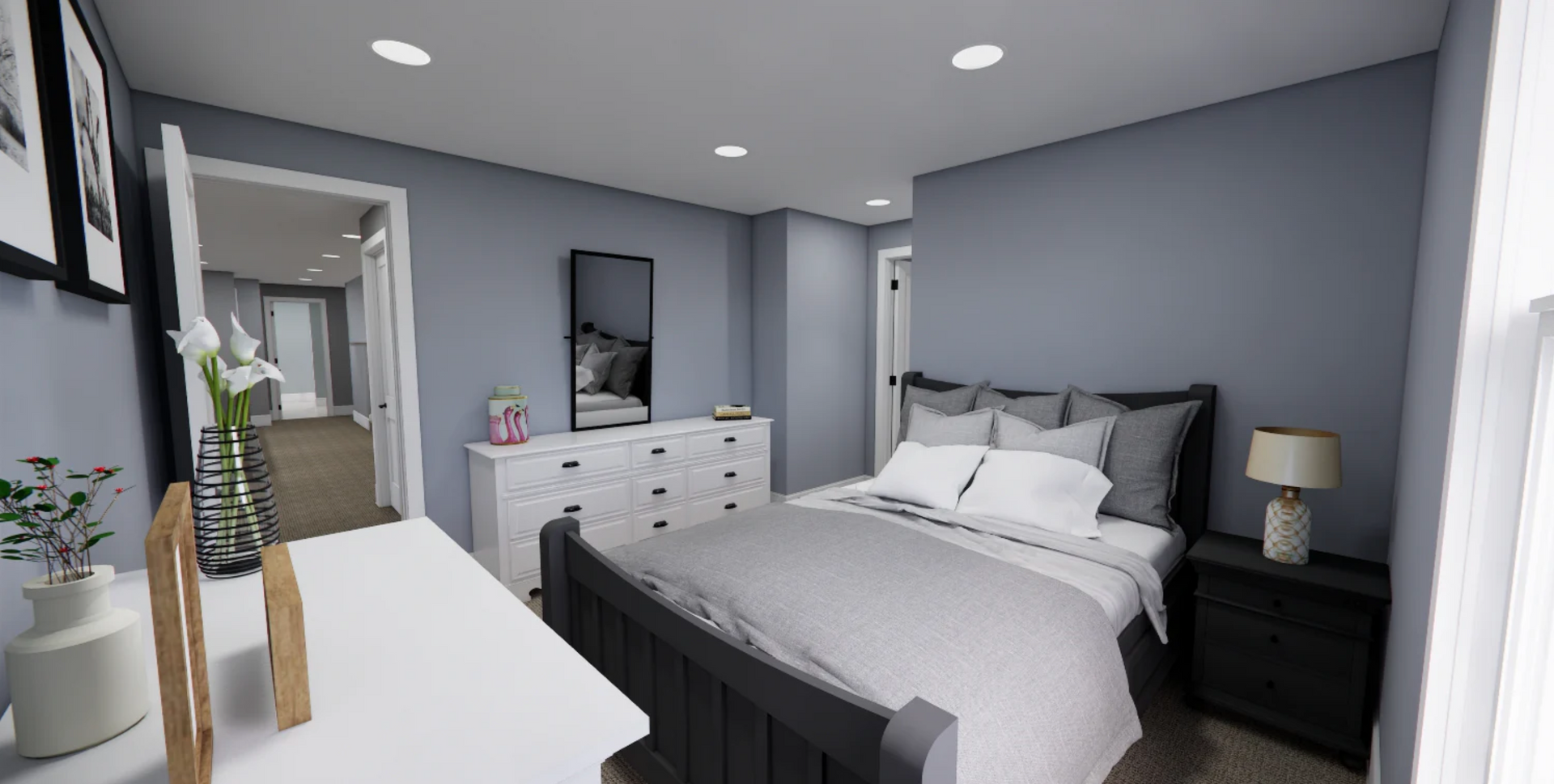 A bedroom with a bed , dresser , nightstand and mirror.