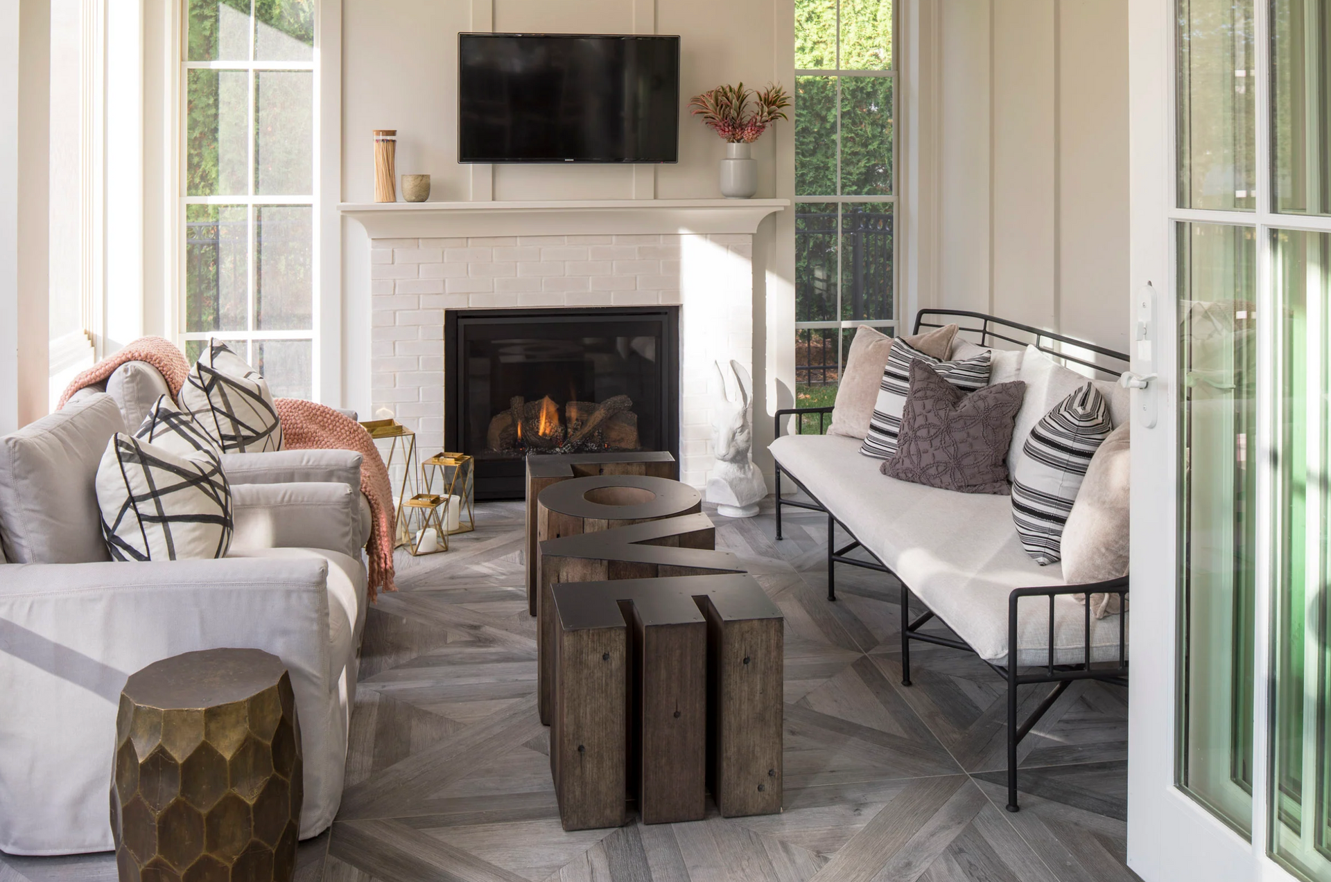 A living room with a fireplace , couch , chairs and a television.