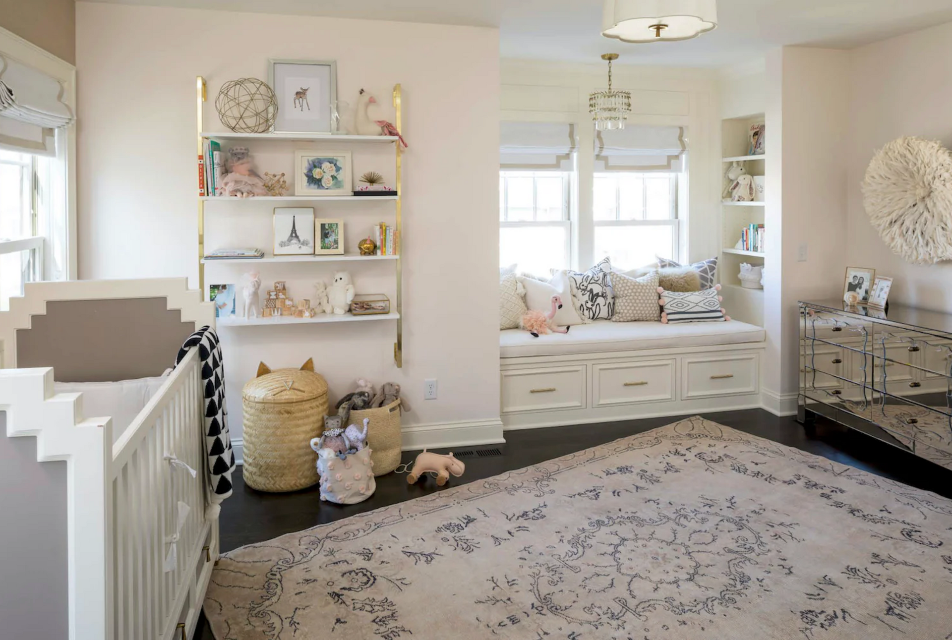 A nursery with a crib and a window seat