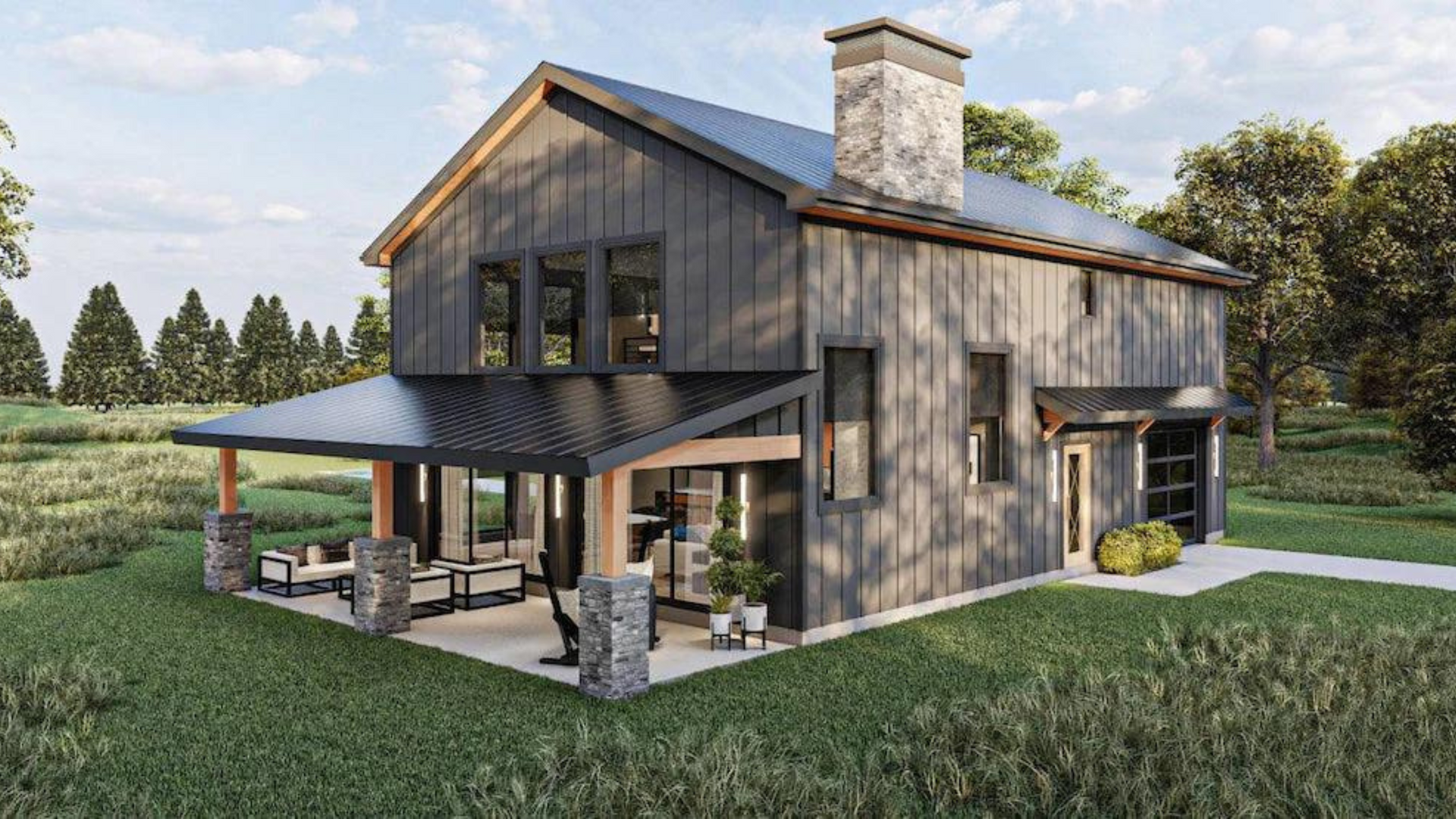 gray residential barndominium with gorgeous back deck