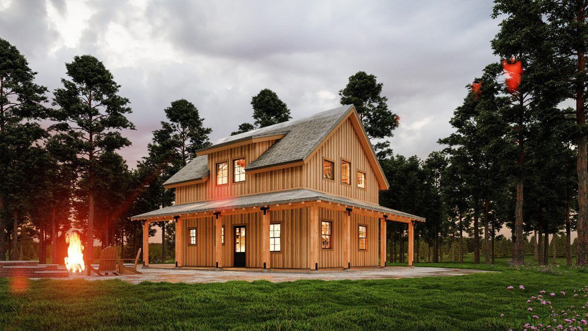 A wooden house with a fire pit in front of it in the woods.