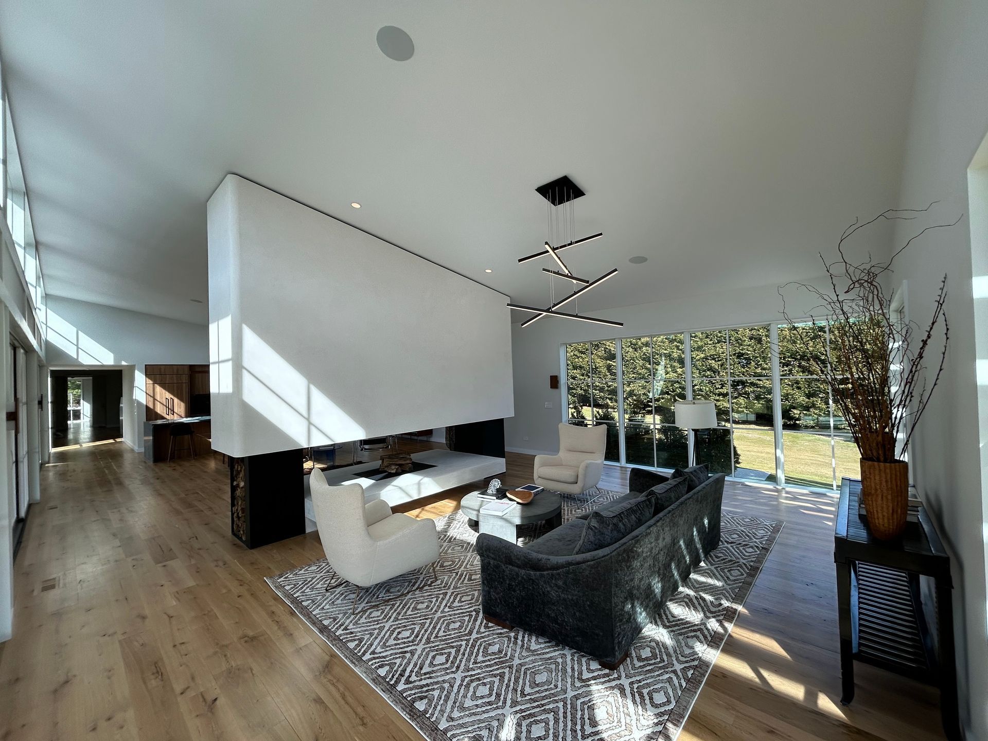 A living room with a couch , chairs and a rug