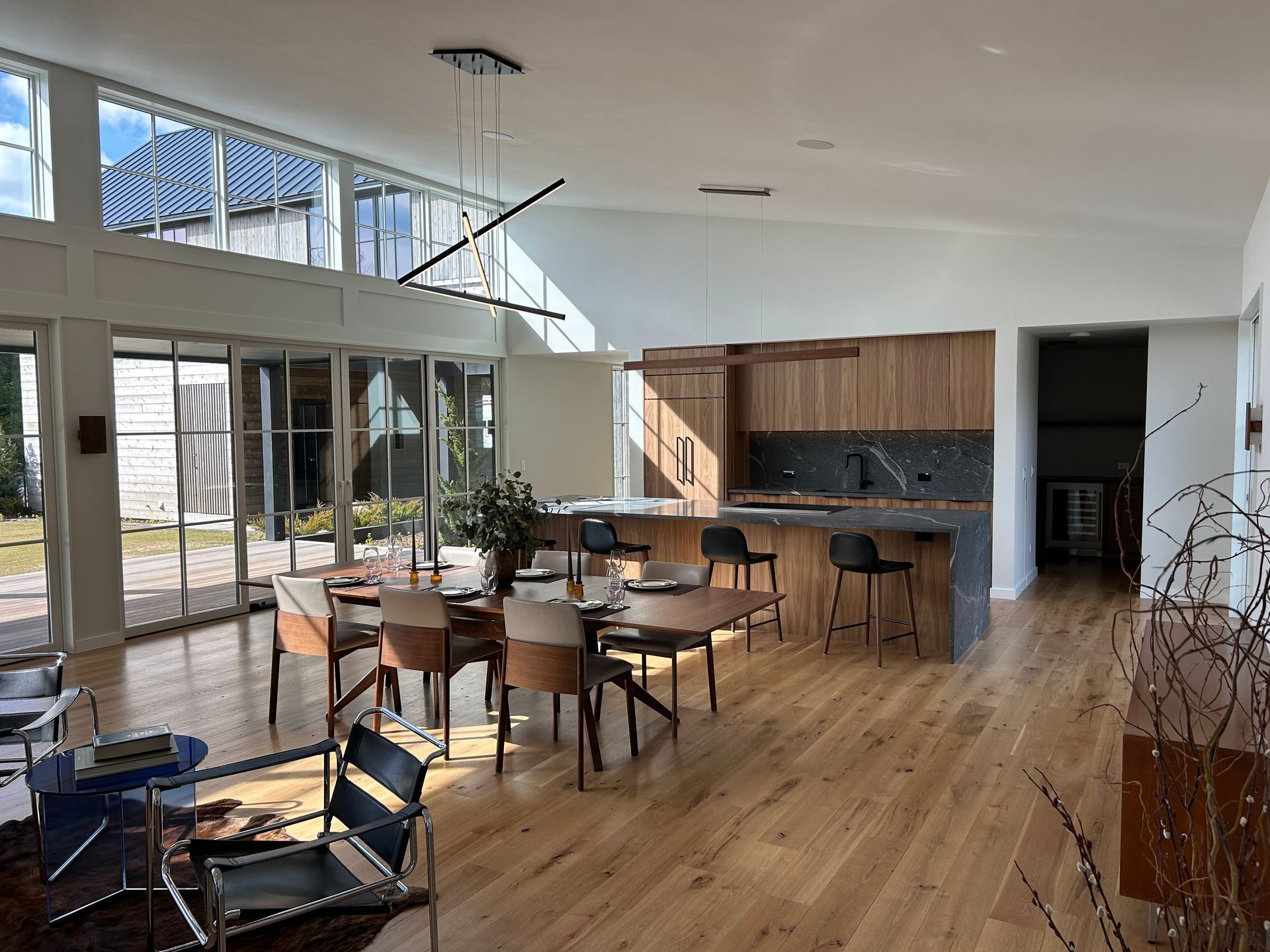 A large room with a dining table and chairs and a kitchen.