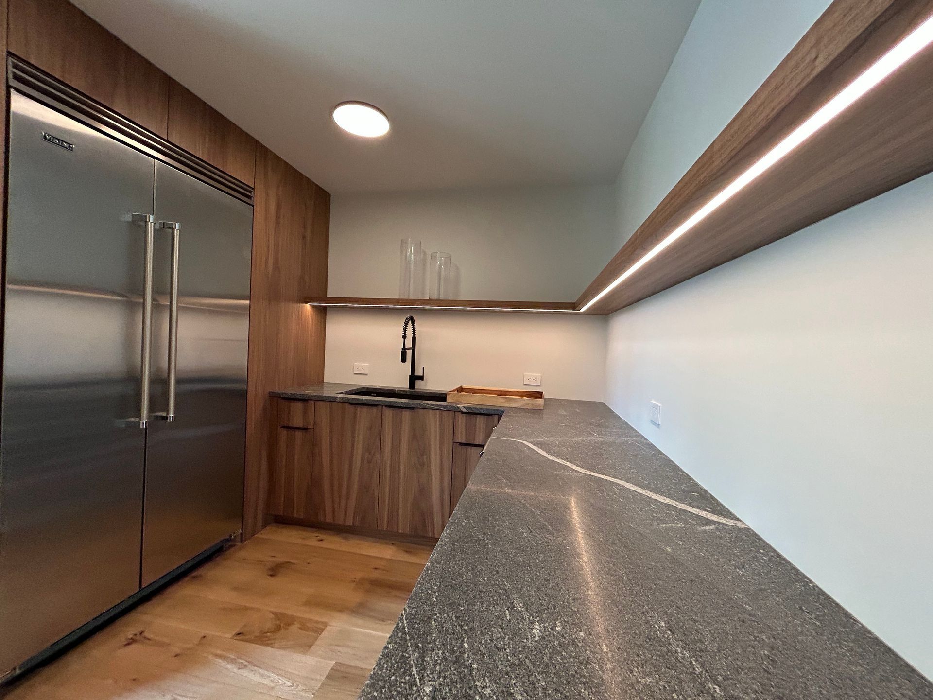 A kitchen with stainless steel appliances and granite counter tops