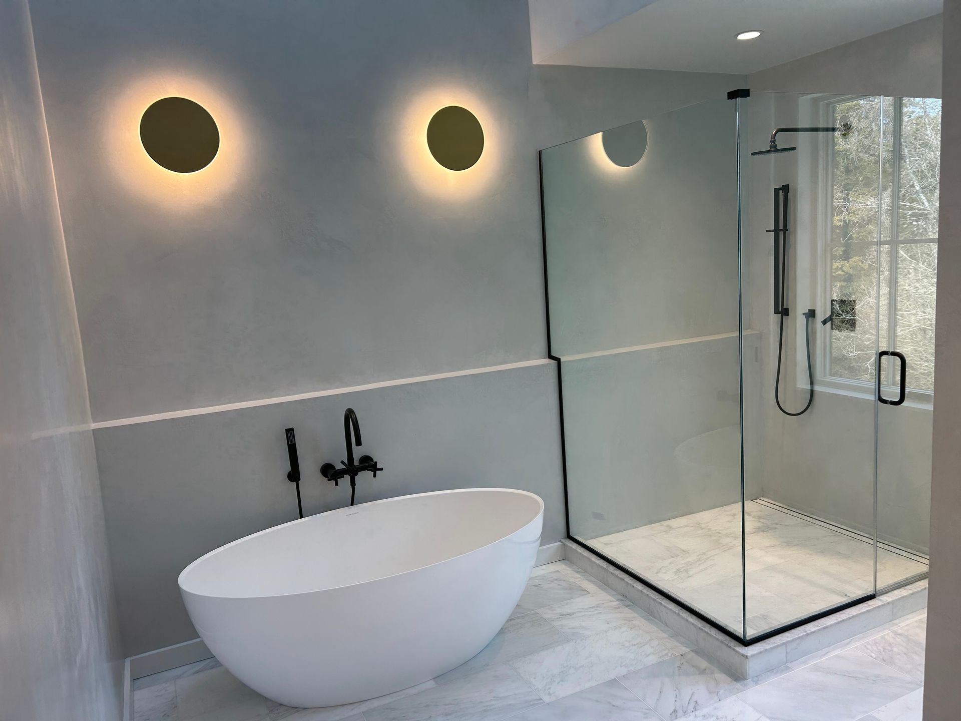 A bathroom with a bathtub and a walk in shower