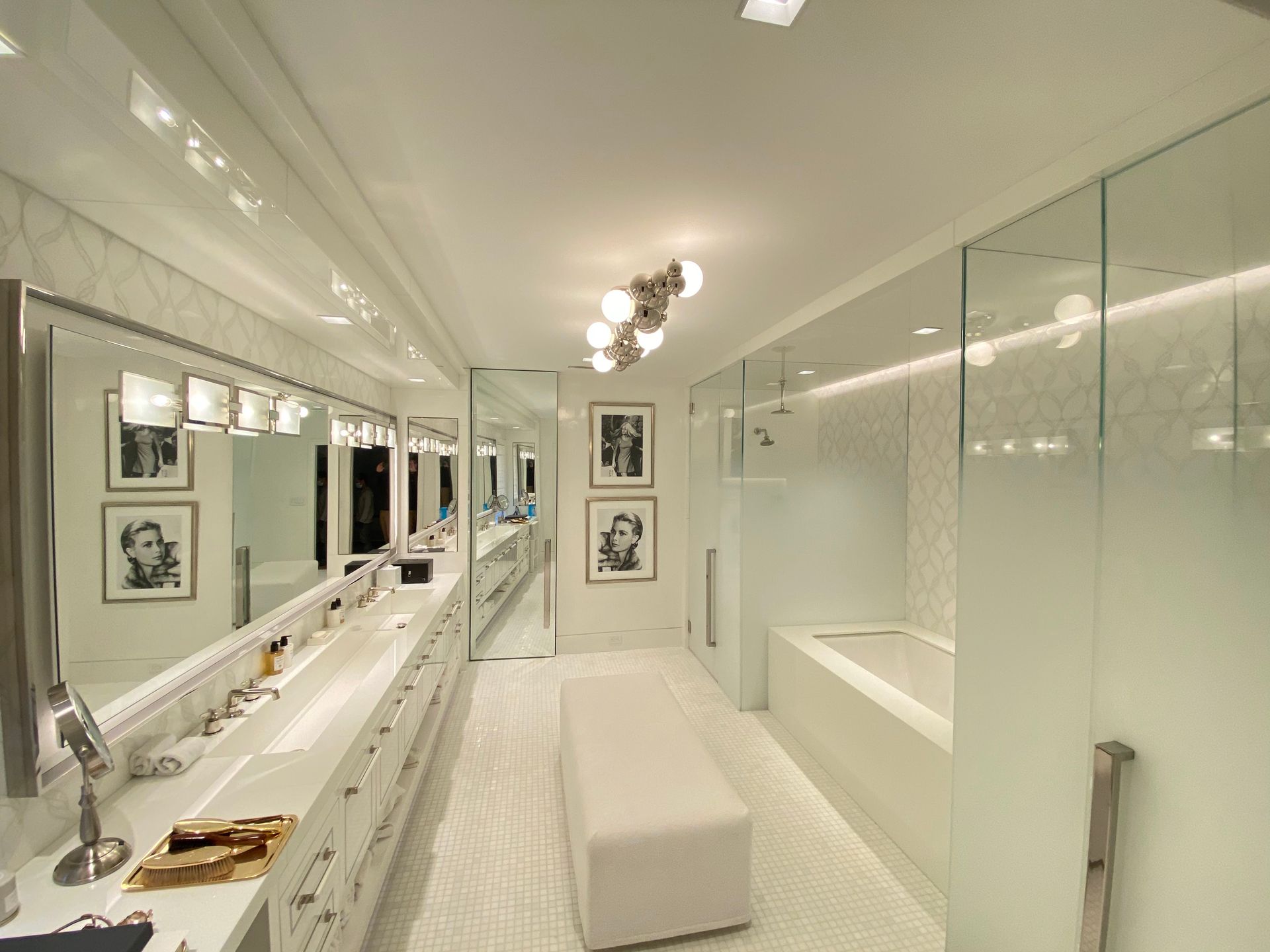 A bathroom with a lot of mirrors and a bench
