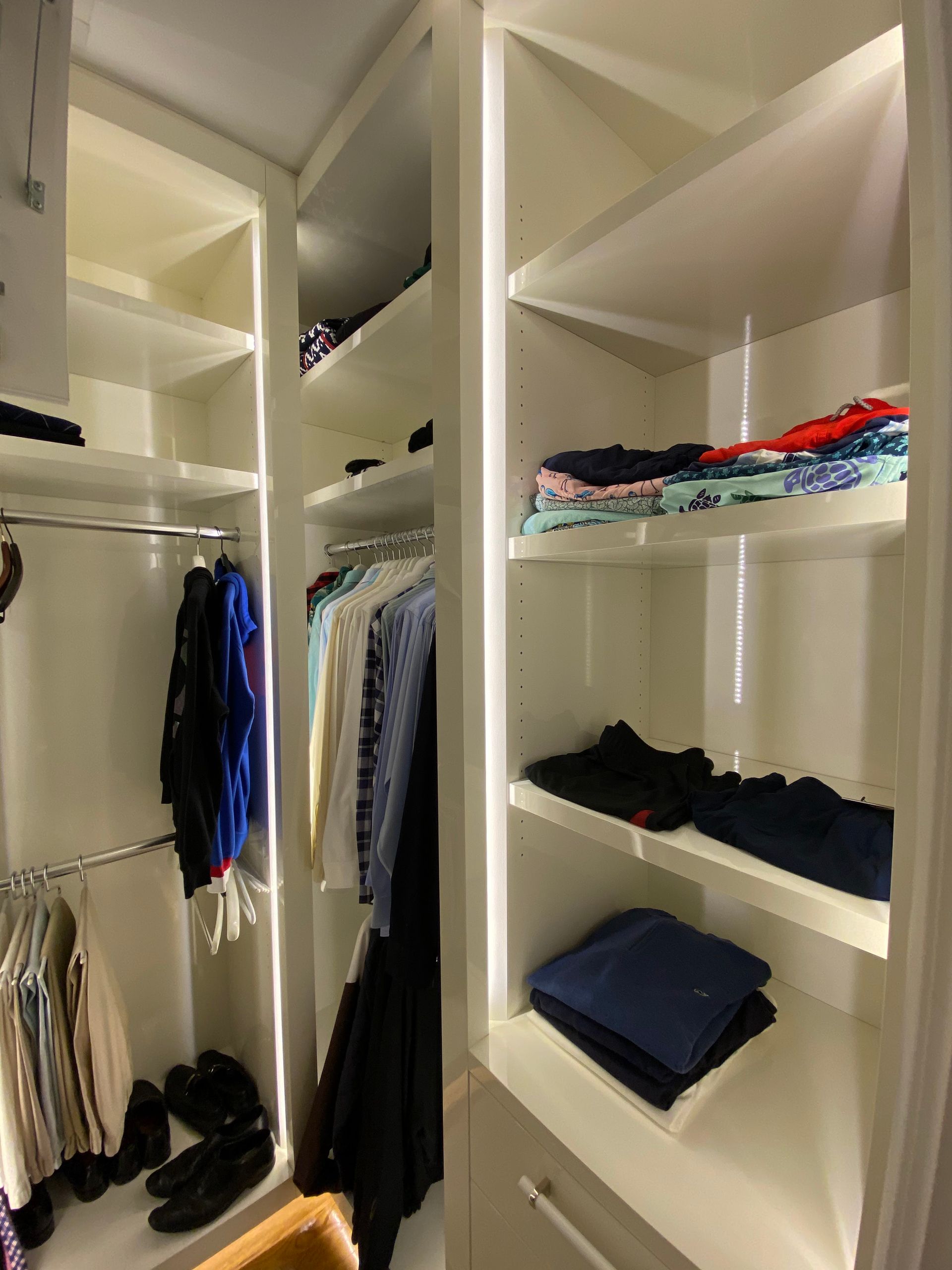 A walk in closet filled with clothes and shoes