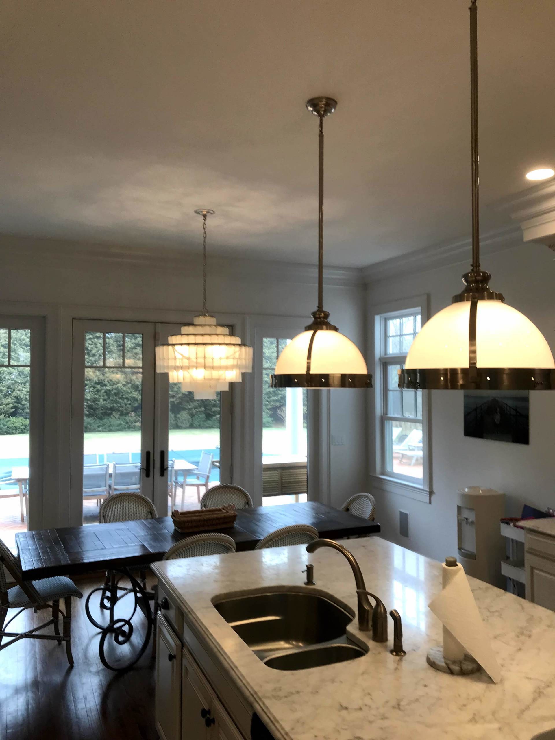 A kitchen with a sink and a table and chairs