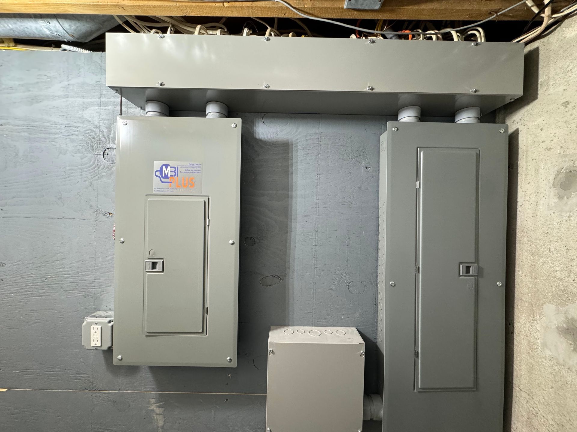 A bunch of electrical boxes are hanging on a wall.