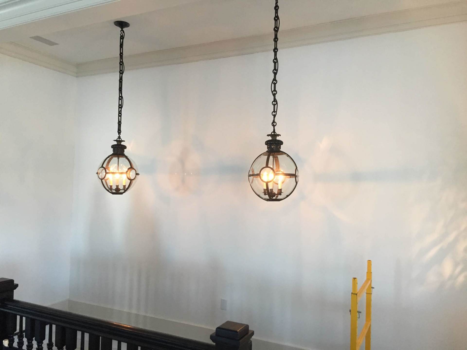 Two pendant lights are hanging from the ceiling in a room